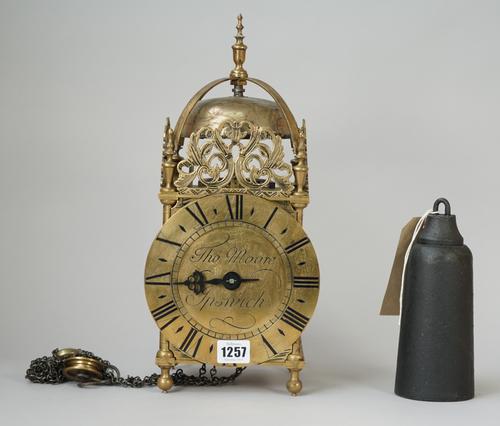 A brass lantern clock, the 6.5inch dial detailed Thomas Moore Ipswich, 37cm high (brass cased lead pendulum and one cast iron weight).
