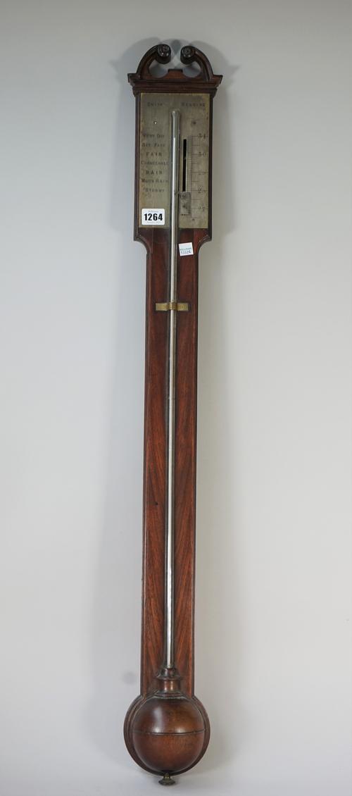 A Victorian mahogany stick barometer, by Smith Reading, with broken arch pediment, silvered rectangular plate, clear glass tube and half black cistern