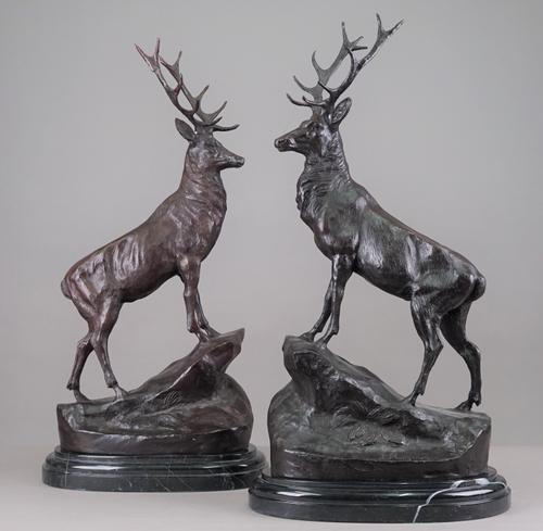 After Moignez; a pair of bronze stags, late 20th century, on shaped marble plinths, 72cm high, (2). Illustrated.