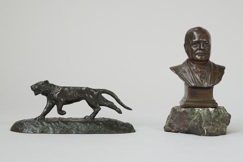 Three small bronzes, early 20th century, comprising; a tiger, 12.5cm wide, a bust of Winston Churchill, indistinctly signed on a hardstone base, bronz