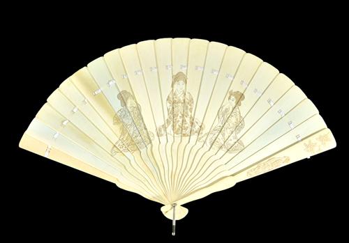 A Japanese ivory fan, late 19th century, carved to both sides with three female figures 'speak no evil, hear no evil, see no evil', stick guard 24cm a