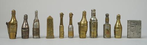 Two novelty Vesta/cigar cutters, early 20th century, each modelled as a 'Veuve Cliqot' champagne bottle (7cm), three 'wine bottle' cigar cutters/prick