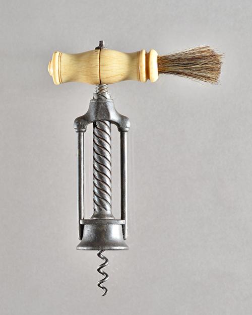 A mid 19th century, twin pillar open rack corkscrew with turned bone handle and brush over a wire helix. Illustrated.