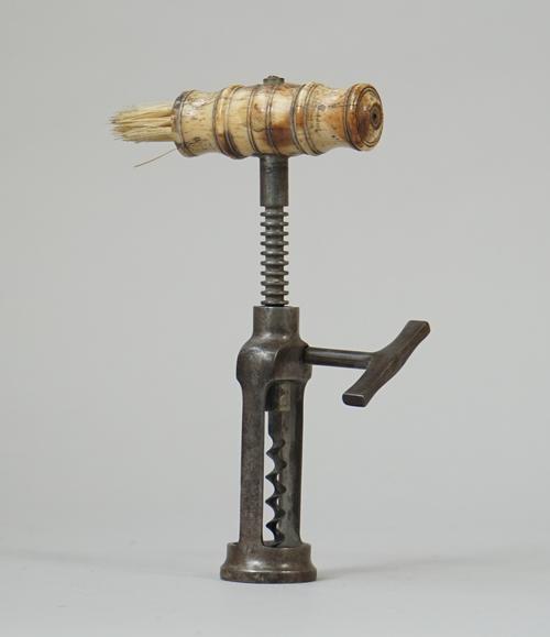 A mid 19th century, twin pillar open rack corkscrew with turned bone handle and brush, steel side handle and wire helix.