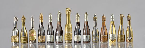 Fourteen novelty cigar cutters and prickers, early 20th century, brass, bone and horn, each modelled as a champagne bottles including; Bollinger, Kupf