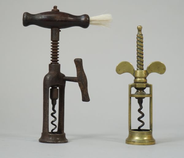 A 19th century brass 'wingnut' corkscrew of twin pillar open barrel form, and a rosewood handled double pillar open frame corkscrew with steel side ha