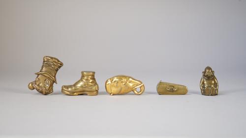Five brass novelty vestas, early 20th century, comprising; a violin case, an elephant's head, a boot, an Imp and a Victorian gentleman wearing a tall