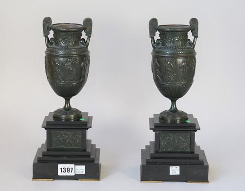 A pair of bronze urn form garnitures, late 19th century, each after the 'Townly' vases on black slate marble bases, 31cm high overall, (2).