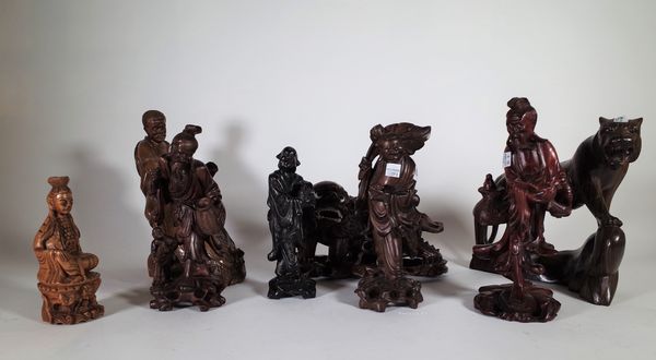 A group of eight 20th century Chinese hardwood figures, including; a tiger, a dog of Fo and a fisherman, the largest 26cm high, (8). S3M