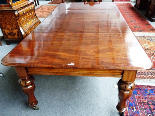 A William IV mahogany extending dining table on lappet carved octagonal baluster supports, two extra leaves, 135cm wide x 152cm long x 272cm long full