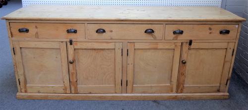 A large Victorian pine dresser base with three frieze drawers over two pairs of cupboards, 228cm wide x 91 cm high.