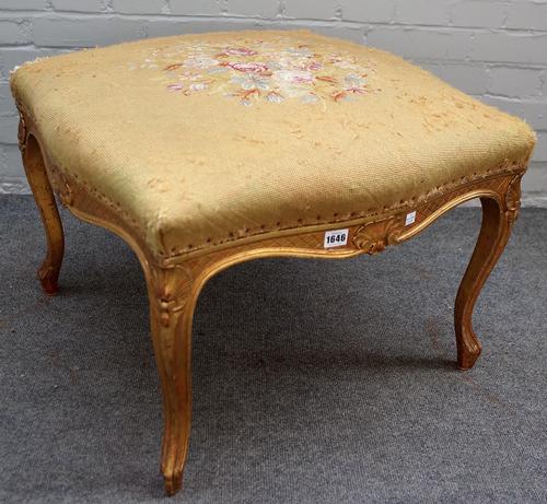 A Louis XV style gilt framed foot stool of square serpentine outline on shell capped cabriole supports, stencil marked 'AU BON MARCHE MASION ARISTIDE