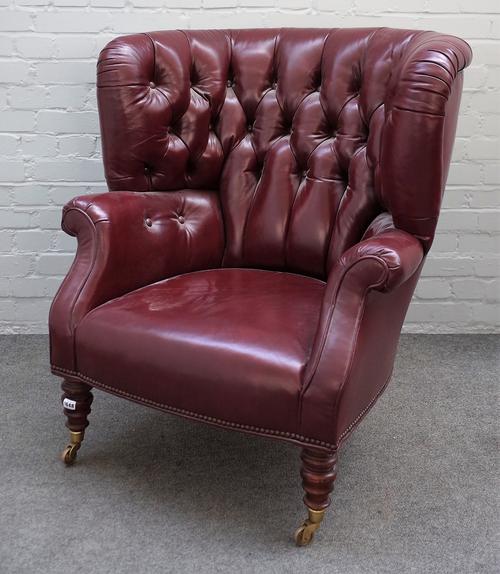 Baker Furniture; a 20th century rouge leather upholstered tub back armchair, on turned supports, 82cm wide x 100cm high.