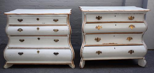 A near pair of early 19th century and later Dutch parcel gilt and white painted bombe four drawer commodes, 99cm wide x 85cm high.