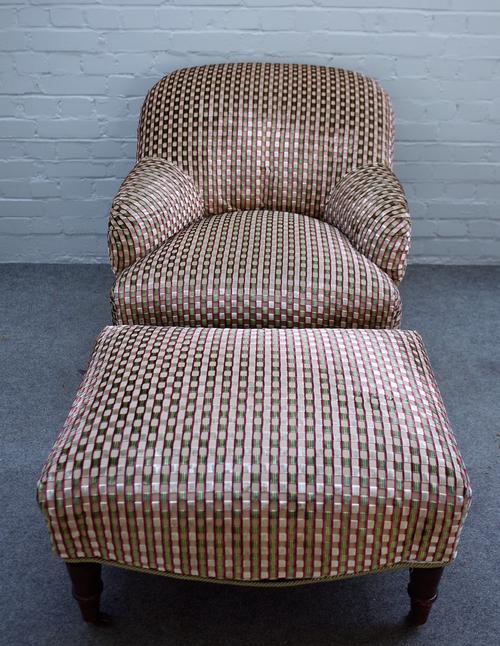 A 20th century tub back easy armchair, on turned supports, together with matching footstool, 80cm wide x 80cm high.