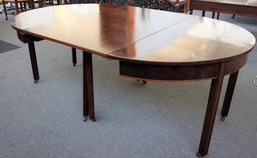 A George III and later mahogany 'D' end extending dining table on block supports, one extra leaf, 132cm wide x 122cm long x 202cm long extended.