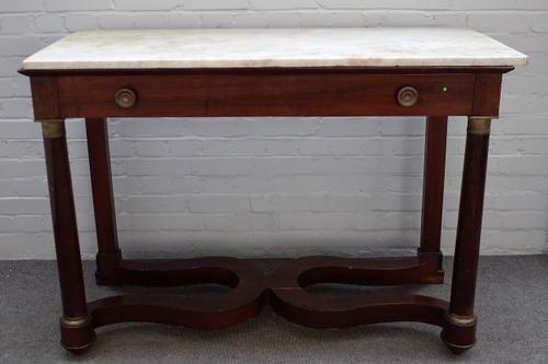 A French Empire console table, the rectangular marble top over gilt metal mounted mahogany single drawer base, 131cm wide x 92cm high.