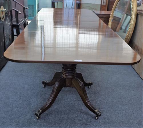 A George III and later mahogany twin pedestal extending dining table, on eight downswept supports, two extra leaves, 106cm wide x 206cm long, 300cm lo