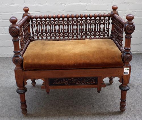 A late 19th century North African bench with extensive bobbin turned decoration, 71cm wide x 66cm high.