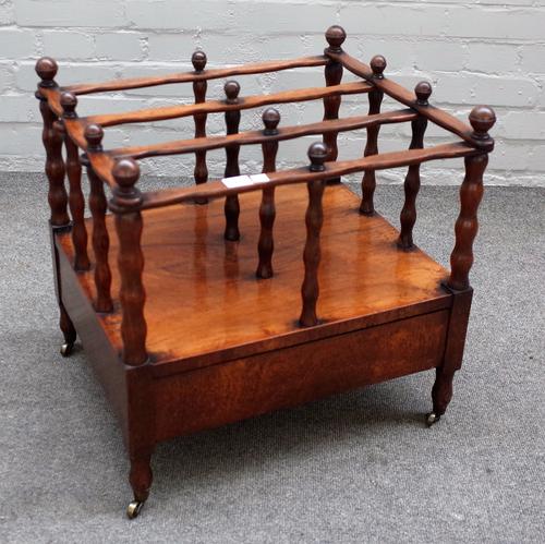 A Victorian rosewood three division Canterbury with single drawer base on turned supports, 50cm wide x 51cm high.