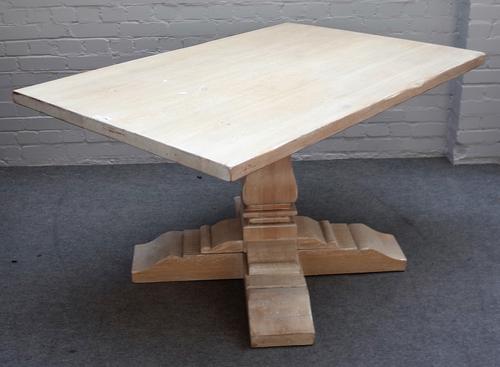 A 20th century limed oak kitchen table, the rectangular top on square baluster column, 94cm wide x 141cm long.