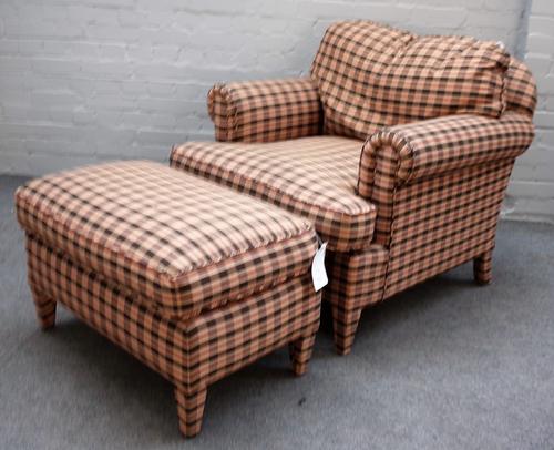 A modern check upholstered easy armchair, on tapering square supports, with matching foot stool, 93cm wide x 80cm high.