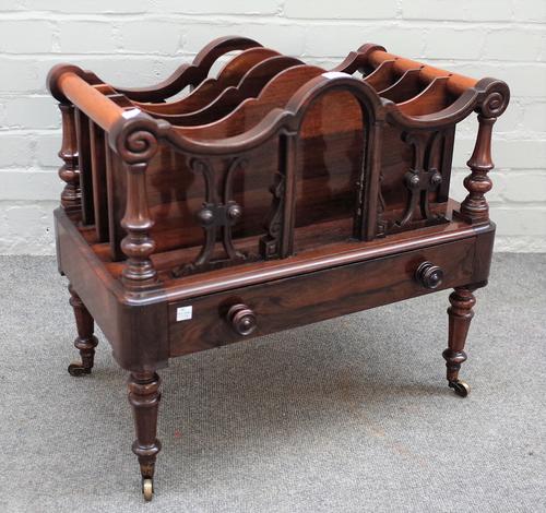 A Victorian rosewood four division Canterbury, with single drawer base on turned supports, 57cm wide x 54cm high.