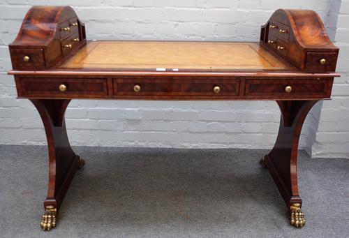Maitland-Smith; a 20th century mahogany writing table, with double dome top fitted with short drawers over three frieze drawers and dummy opposing, on