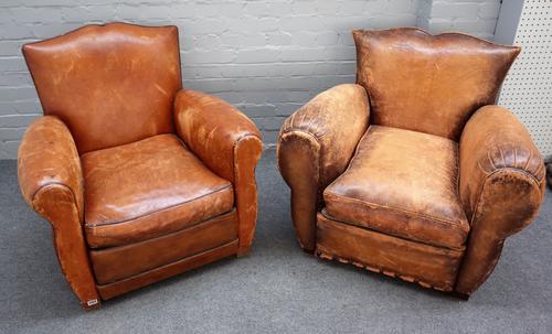 A pair of 20th century French brown leather upholstered easy armchairs on block supports, 83cm wide x 80cm high.