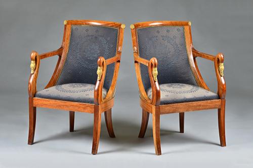 A pair of Empire Revival gilt metal mounted mahogany open armchairs, with swans head finial and sabre supports, 57cm wide x 86cm high. Illustrated.