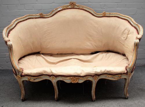 A Louis XV style parcel gilt green painted tub back sofa, on scroll supports, (19th century) 154cm wide x 100cm high.