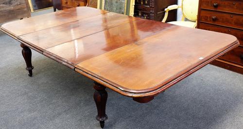 A William IV mahogany extending dining table, on bulbous carved baluster supports, two extra leaves, 135cm wide x 136cm long x 244cm long extended.