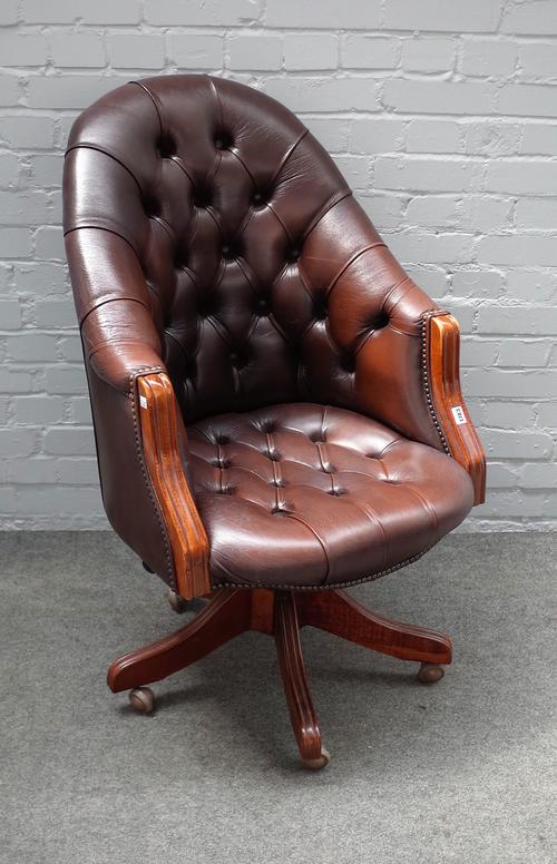 A 20th century studded brown leather upholstered tub back swivel office chair, on five point base, 67cm wide x 105cm high.