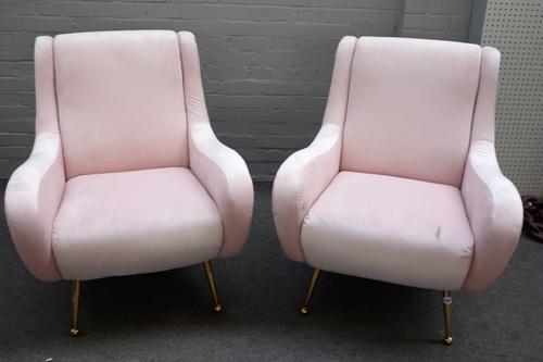 A pair of retro design pink upholstered easy armchairs, on tubular lacquered brass supports, 80cm wide x 92cm high.