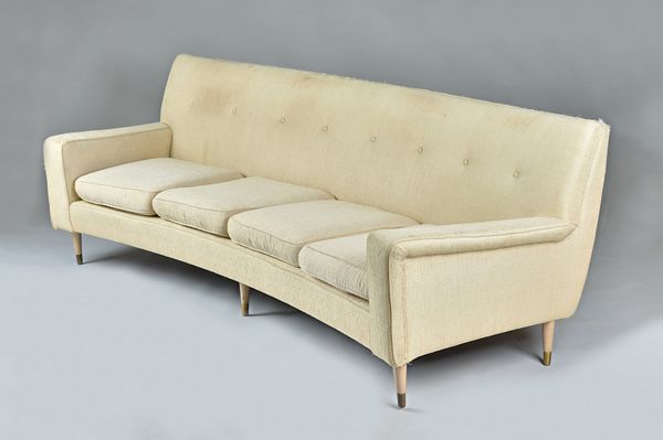 In the manner of Gio Ponti; a mid-20th century cream upholstered curved sofa, on turned tapering beech supports,  220cm wide x 73cm high. Illustrated.