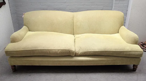 A modern green upholstered double humpback sofa on turned supports, 220cm wide x 85cm high.