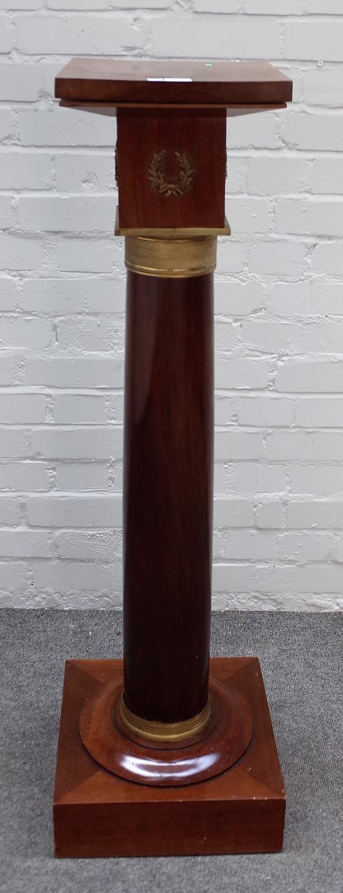 An Empire style gilt metal mounted mahogany pedestal with square top and base on turned column, 35cm wide x 115cm high.