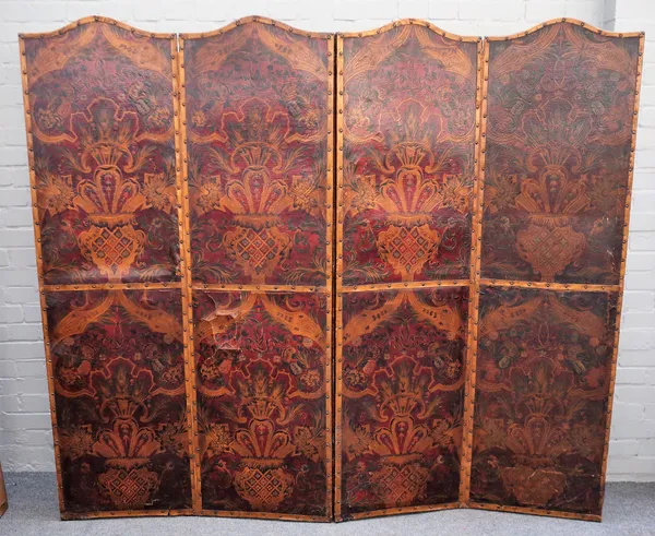 A late 19th century floral polychrome painted embossed leather arched top four fold draft screen, 204cm wide x 180cm high.