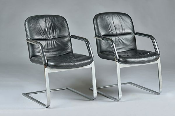 Klober, a pair of black leather and chrome open armchairs, circa 1987, 60cm wide x 87cm high. Illustrated.