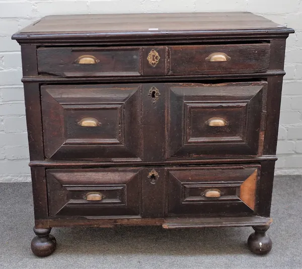 A Charles II oak chest with three long geometric moulded drawers on bun feet, 91cm wide x 84cm high.