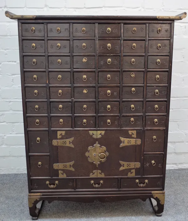 A 20th century Eastern hardwood apothecary cabinet with fifty six drawers and a pair of cupboards, 75cm wide x 97cm high.