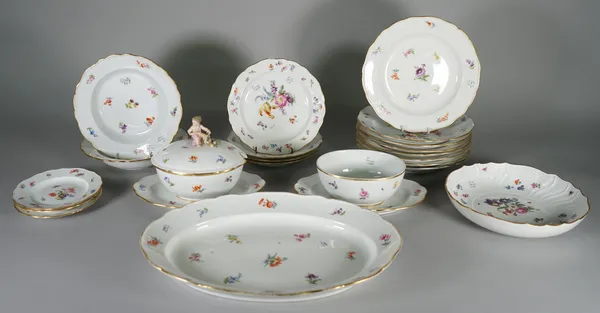A Meissen porcelain composite part service, circa 1900, painted with scattered flowers inside gilt line rims, comprising; a pair of oval sauce tureens