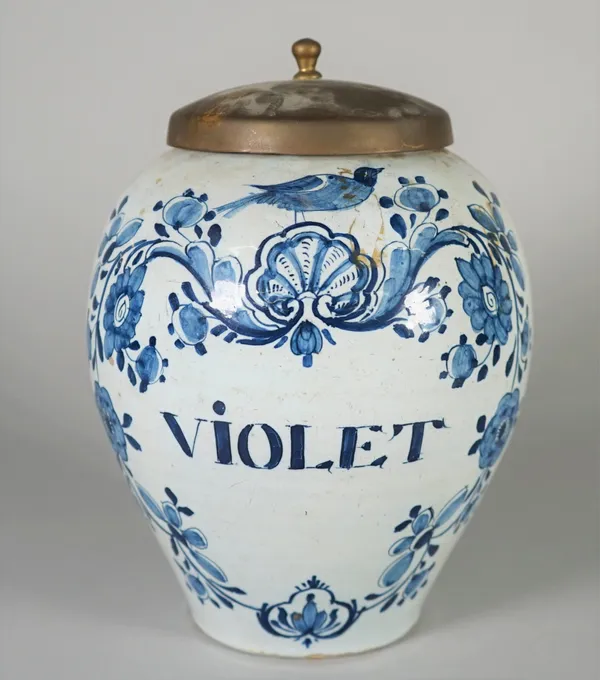 A Dutch Delft blue and white oviform dry drug jar, 18th century, named for `VIOLET', inside a floral and shell cartouche surmounted by a bird, 22cm. h