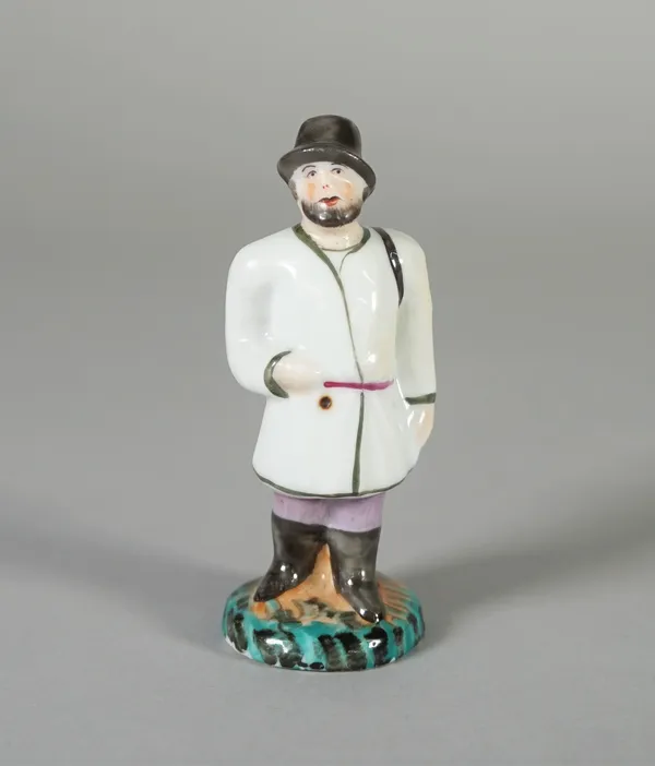 A small Russian porcelain figure of man, Popov factory, Moscow, 19th century, standing on a grassy mound in regional costume, a pan across his shoulde