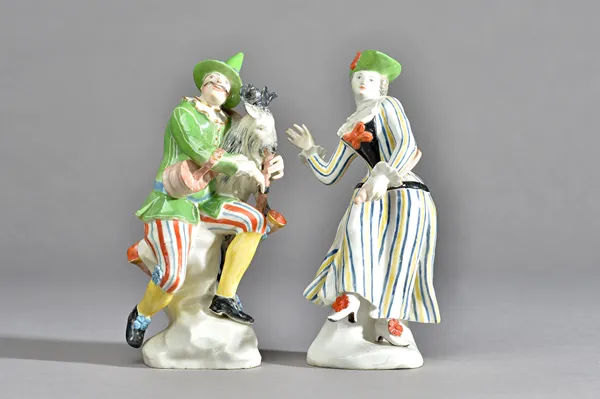 A rare pair of  early Höchst figure of Harlequin and Columbine, circa 1750-53, probably modelled by Johnann Gottfried Becker, Harlequin seated on a ro