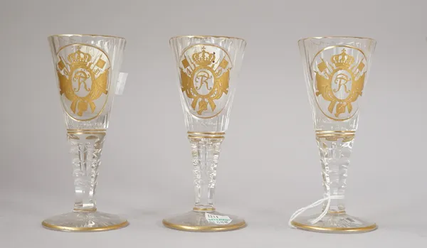 Three Silesian cut and gilt wine glass, early 20th century, the flared and fluted bowls gilt with the FR  monogram of King Frederick the Great within
