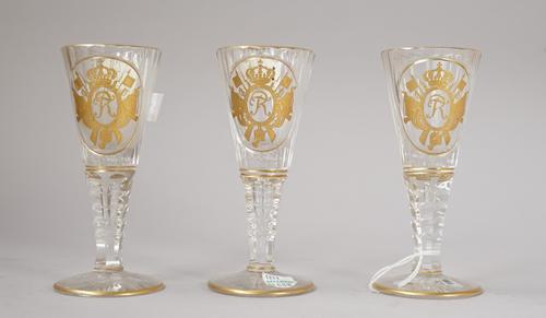 Three Silesian cut and gilt wine glass, early 20th century, the flared and fluted bowls gilt with the FR  monogram of King Frederick the Great within