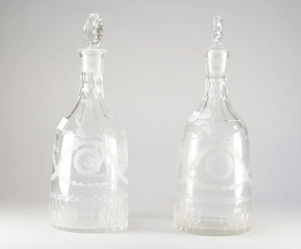A pair of early 20th century engraved glass decanters and matched stoppers, of sugarloaf form, each engraved with bucrania and patera and neo-classica