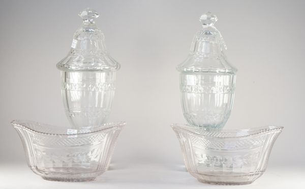 A matched pair of cut glass urns and covers, 19th century, each facet cut body cut with a band of hobnail, raised on a short stem and square base, 31.