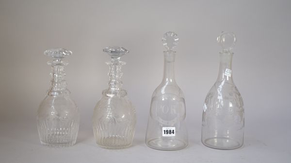 Two sugarloaf glass decanters and stoppers, one with a label engraved for `Port', the other for `White Wine', 19cm. and 19.5cm. high; also a pair of P